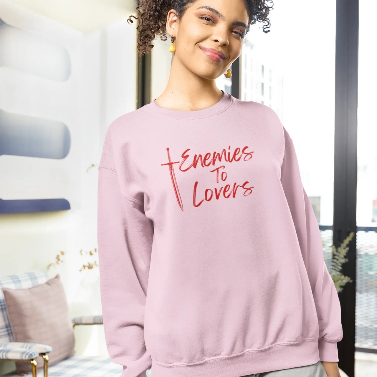 woman wearing a Pink Enemies To Lovers sweatshirt