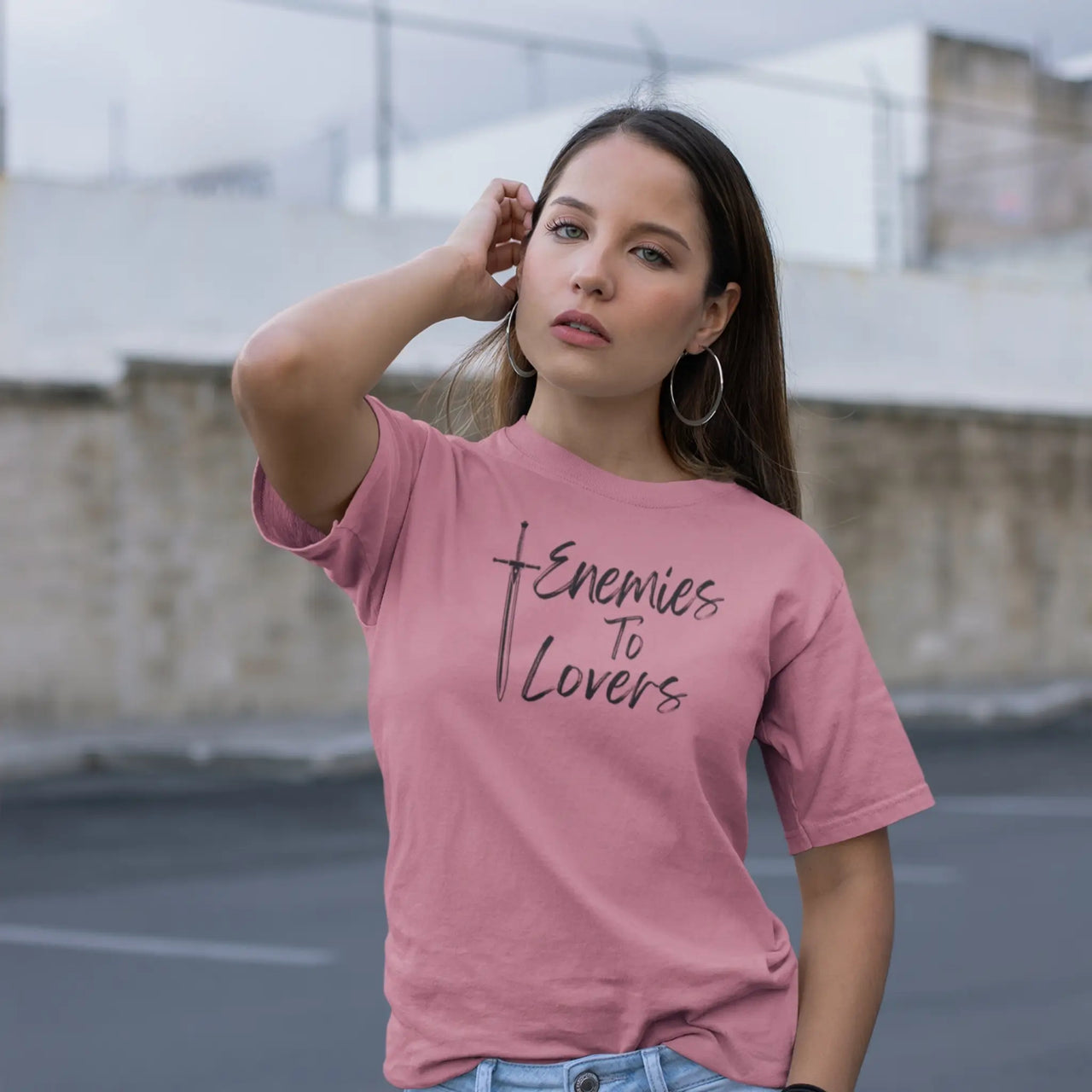 a woman wearing a dark pink Enemies To Lovers Tshirt