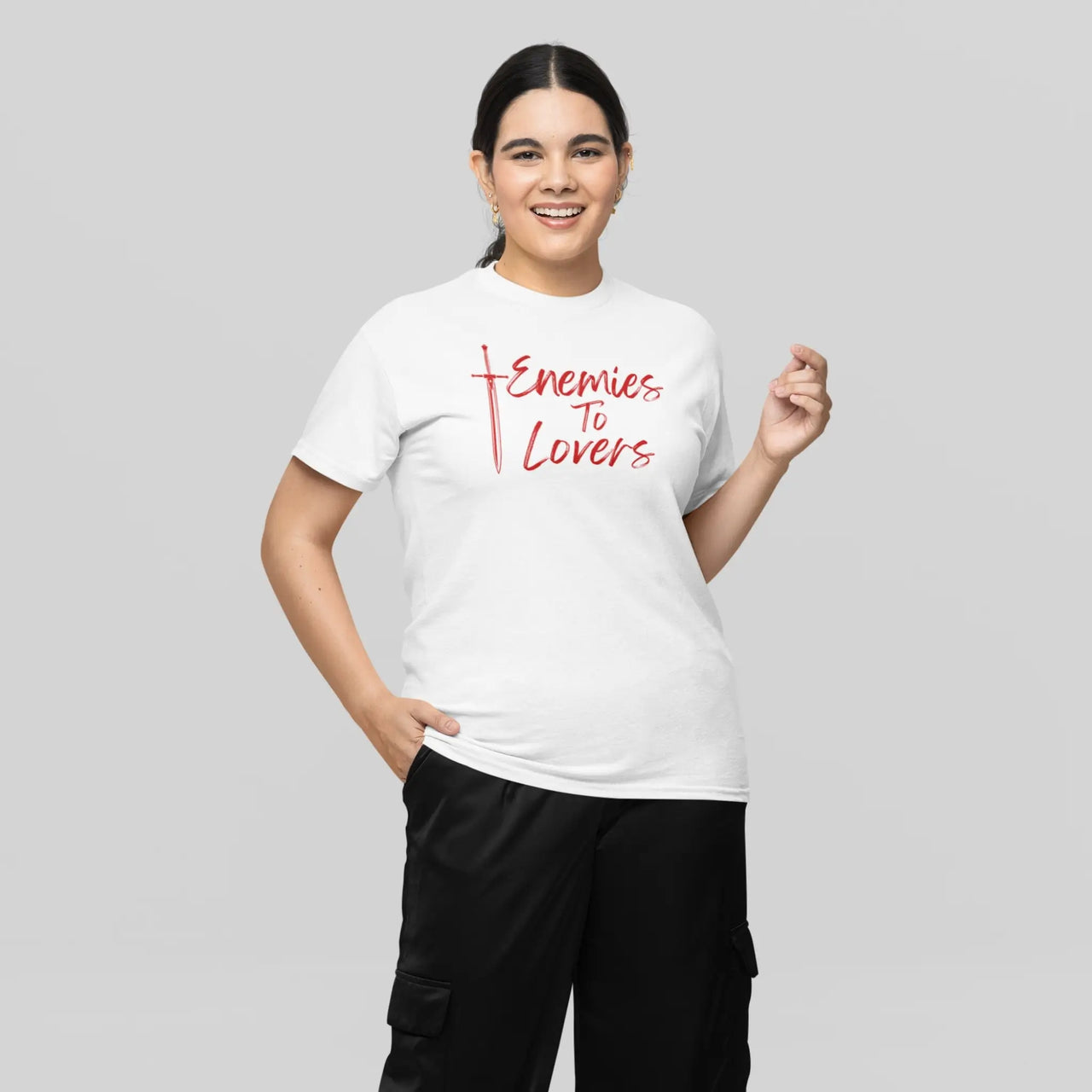 modeling a white enemies to lovers tee with red text