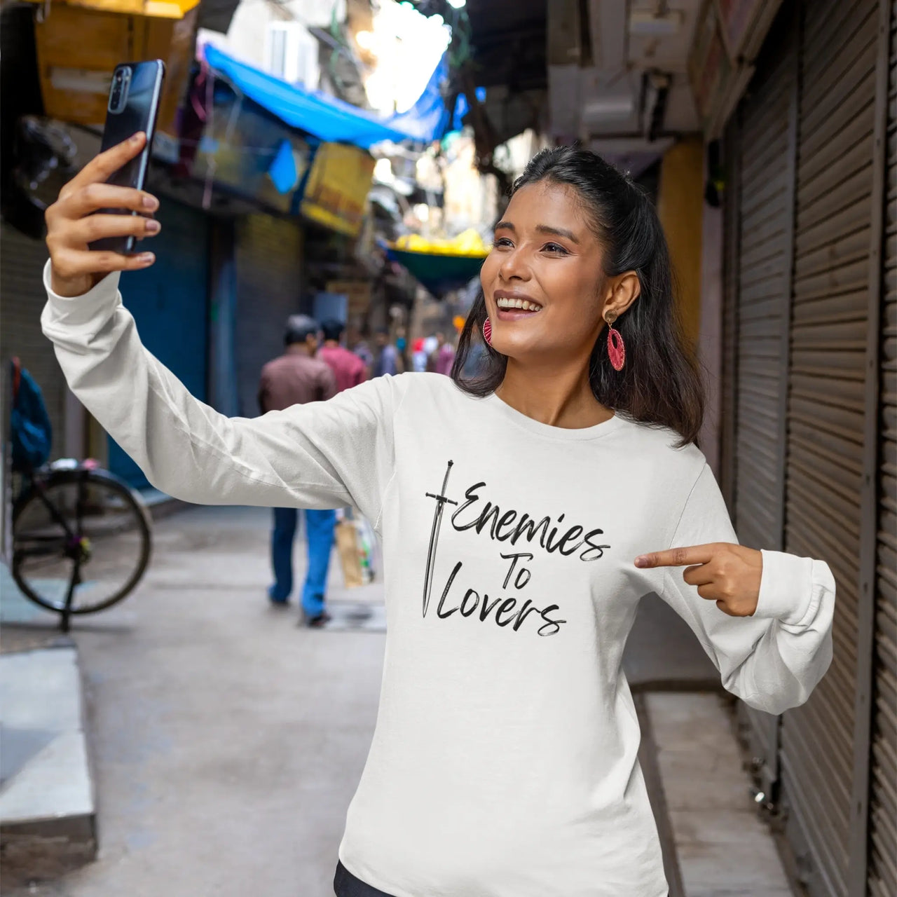 woman showing off her Enemies To Lovers Long Tshirt in white