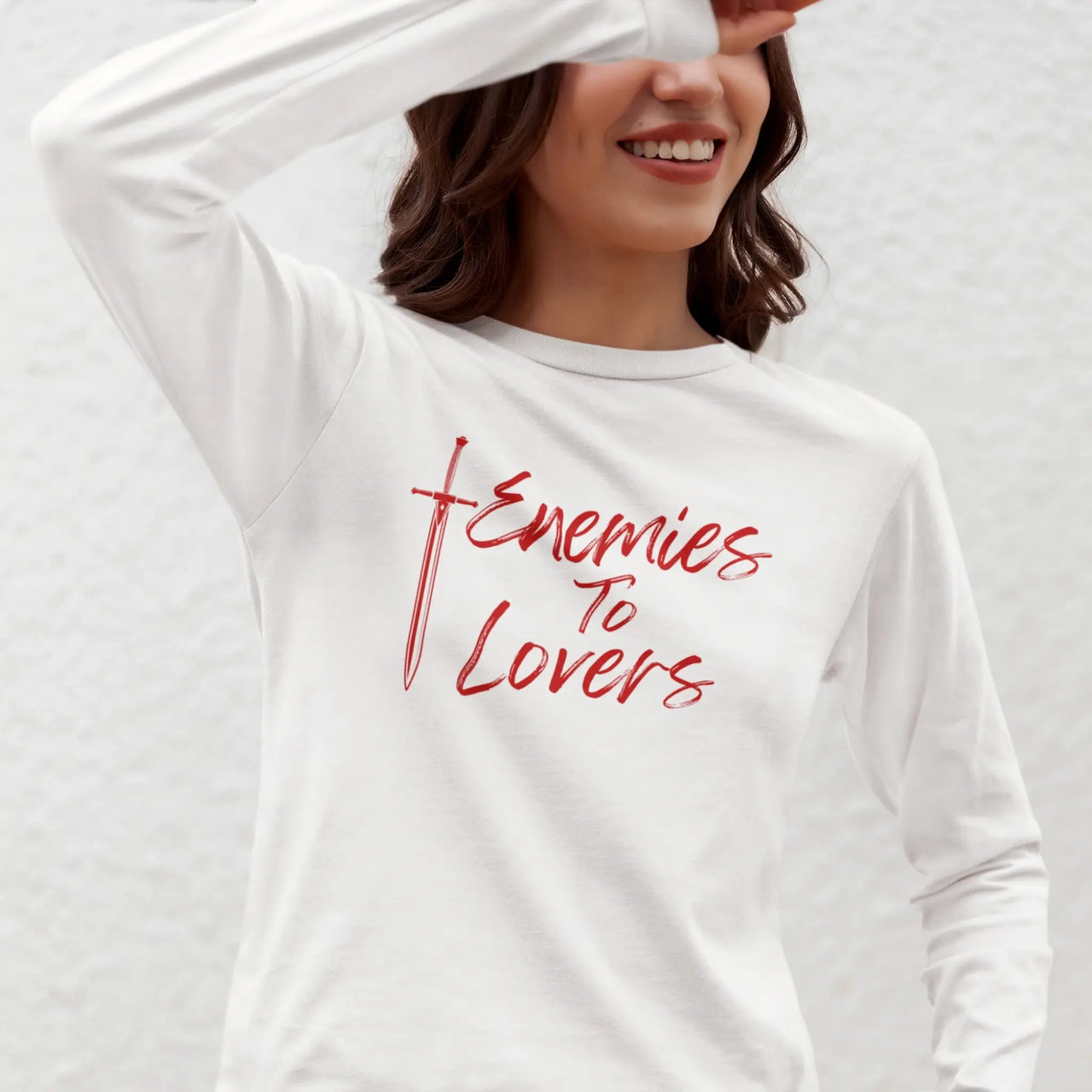 young woman wearing a Enemies To Lovers Long Tshirt in white with red graphics