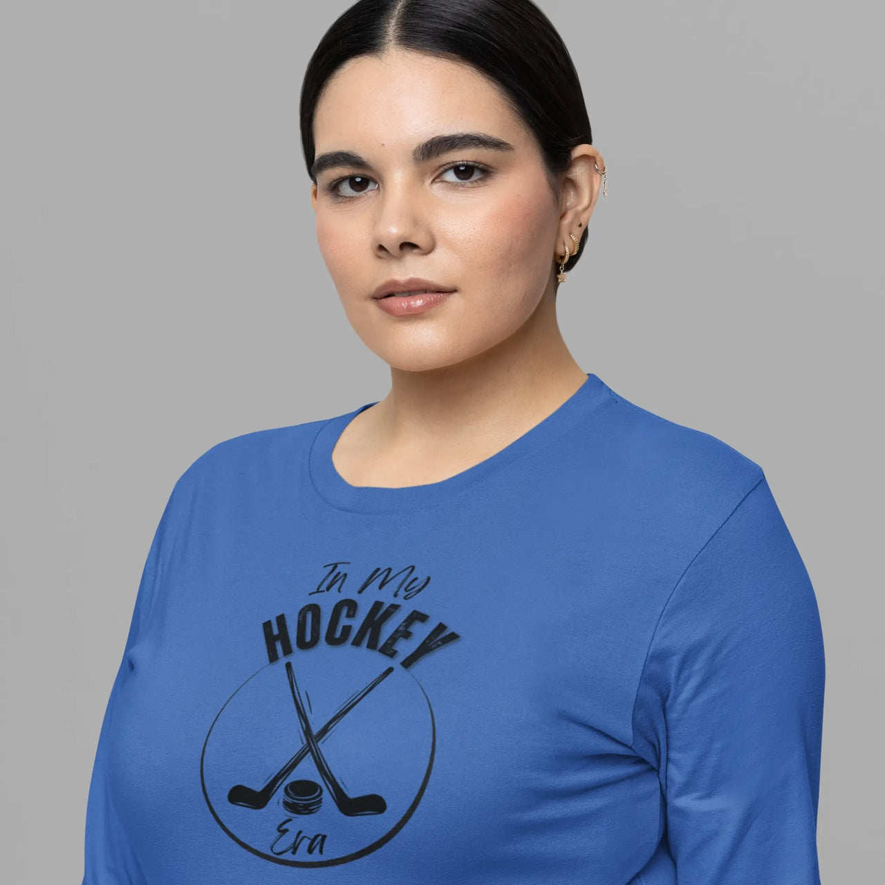 woman wearing an In my Hockey Era long sleeve t-shirt in blue