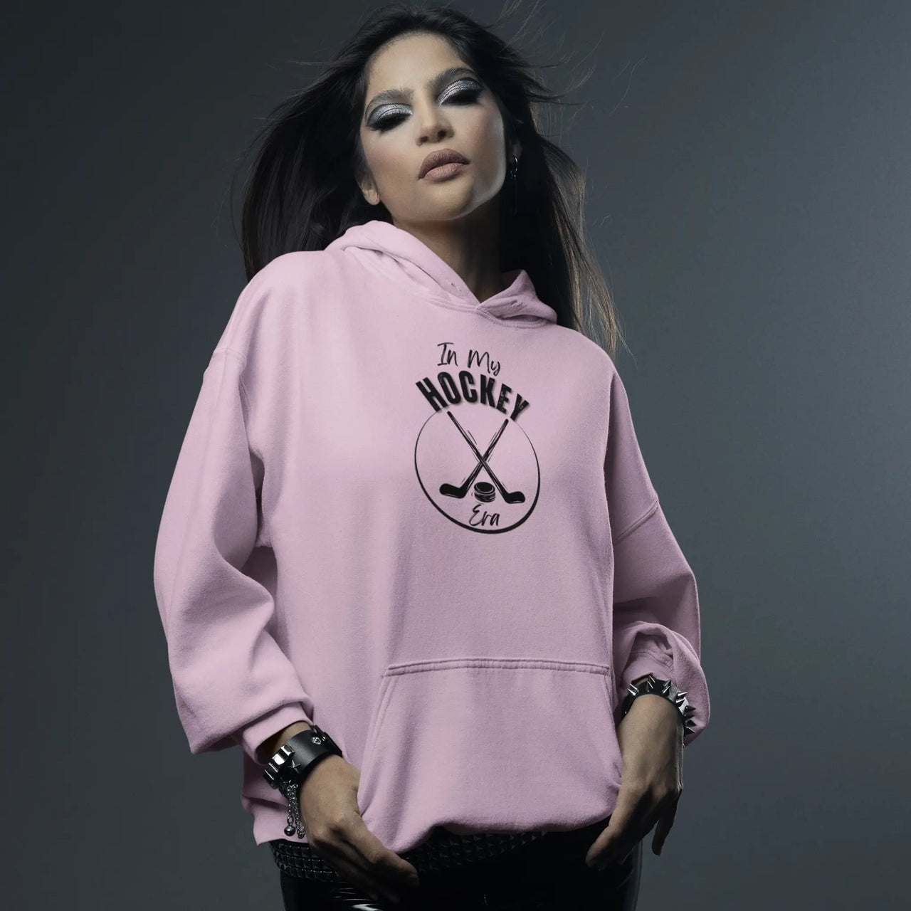 a woman posing in a Pink In My Hockey Era Hoodie