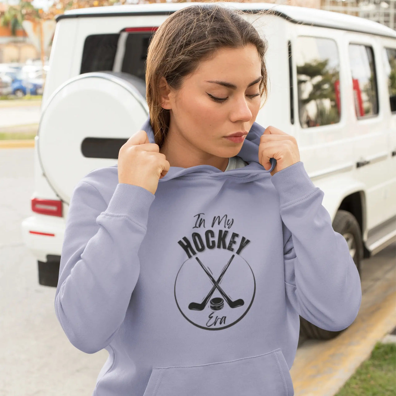 Woman wearing a Violet In My Hockey Era Hoodie