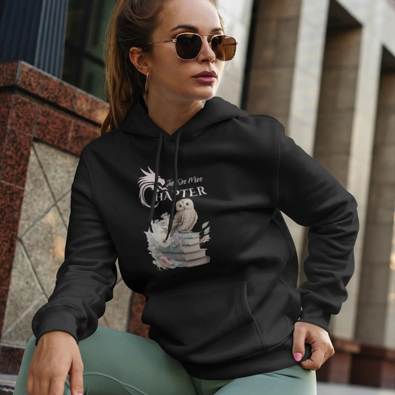 woman wearing a black Just one more chapter hoodie v2