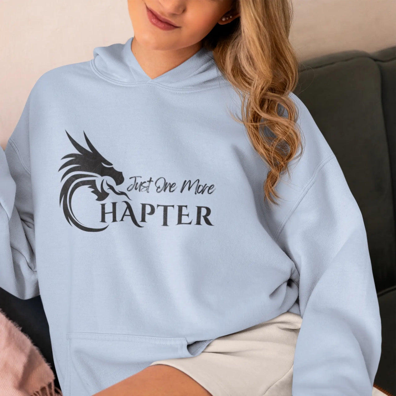 woman wearing a blue Just One More Chapter Hoodie V1 black text