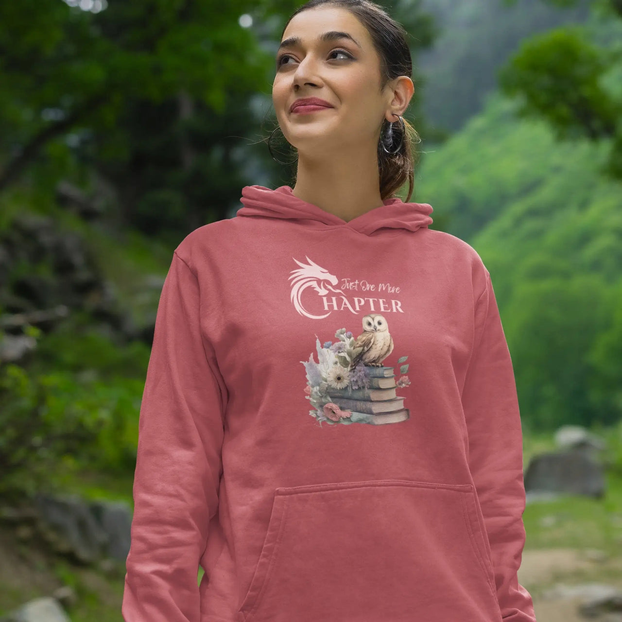 woman smiling while wearing a Dark pink Just one more chapter hoodie v2 with pink text