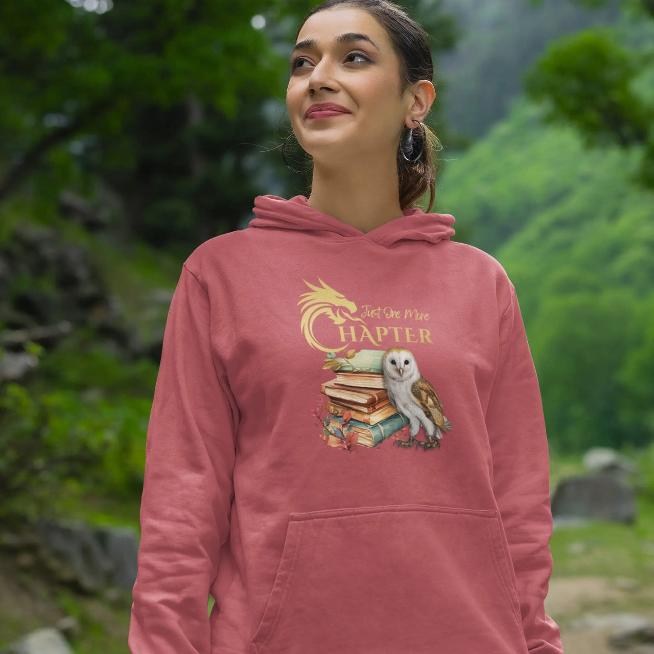 happy woman wearing a Dark Pink Just one more chapter hoodie v3 with gold text