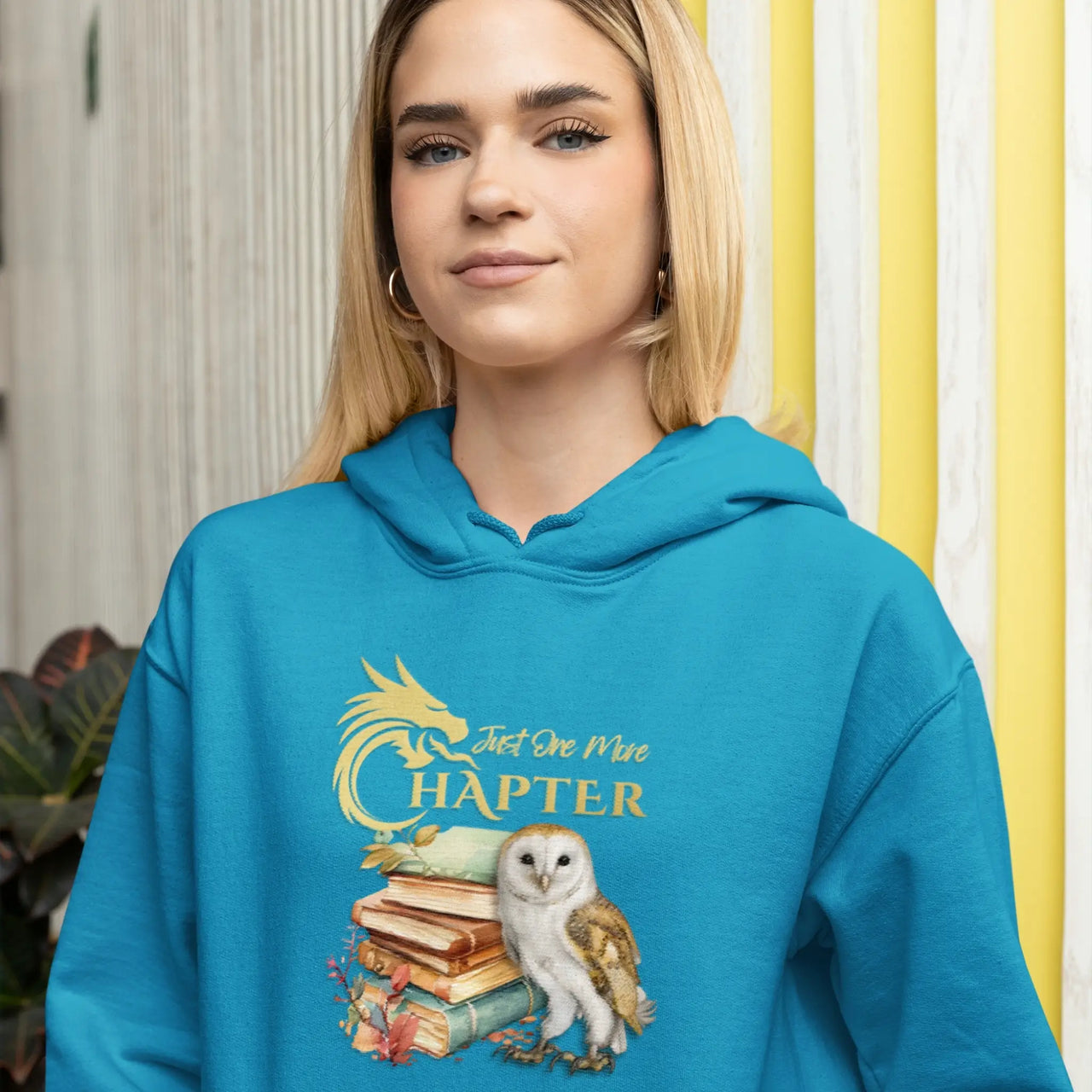 young woman wearing a Teal Just one more chapter hoodie v3 with gold text