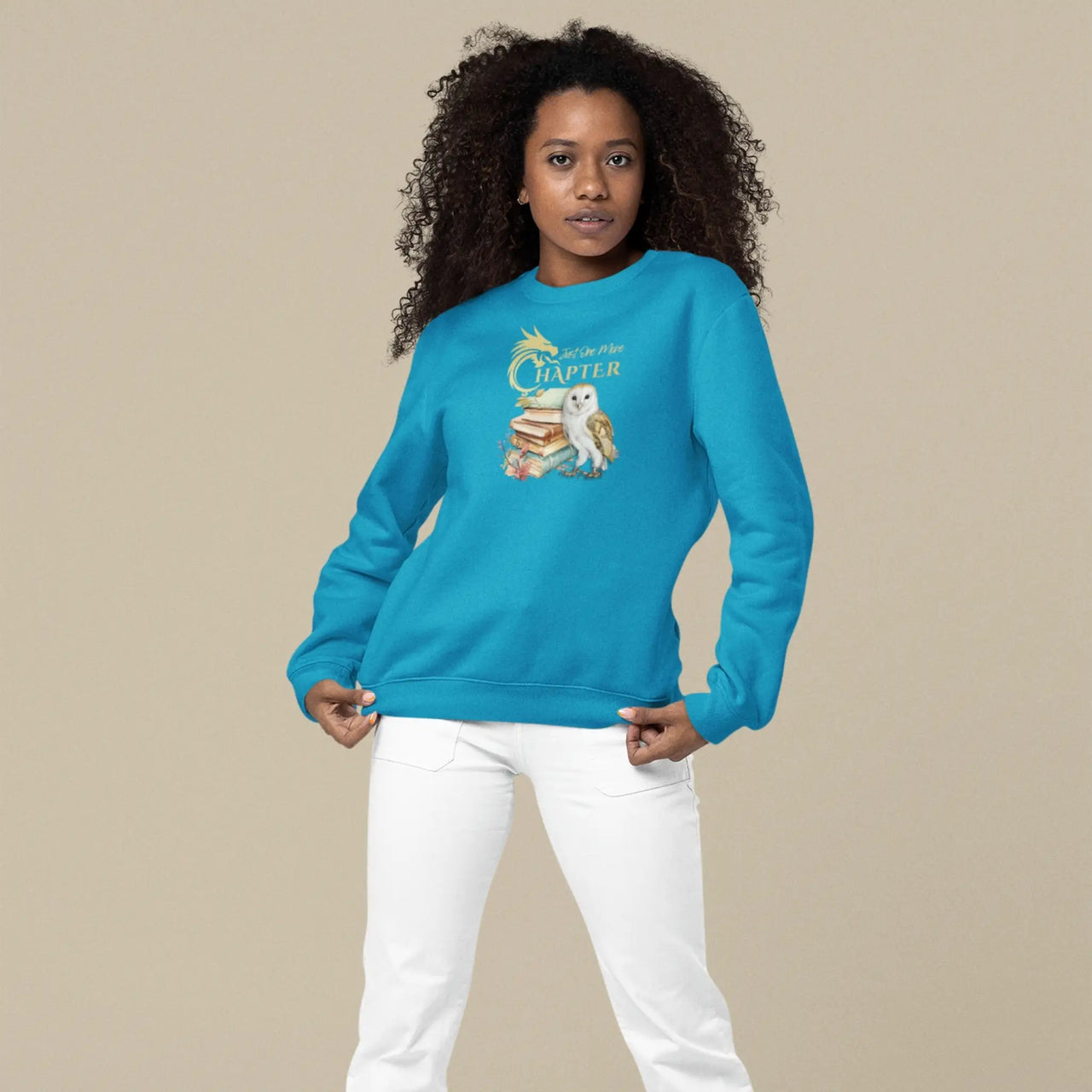 woman displaying a teal Just one more chapter sweatshirt v2 with gold text