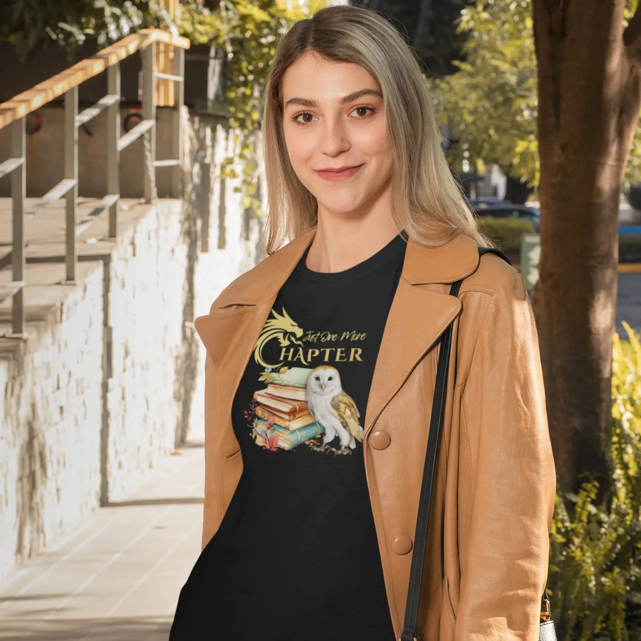 smiling woman wearing a Black Just One More Chapter Tshirt V2 with gold text