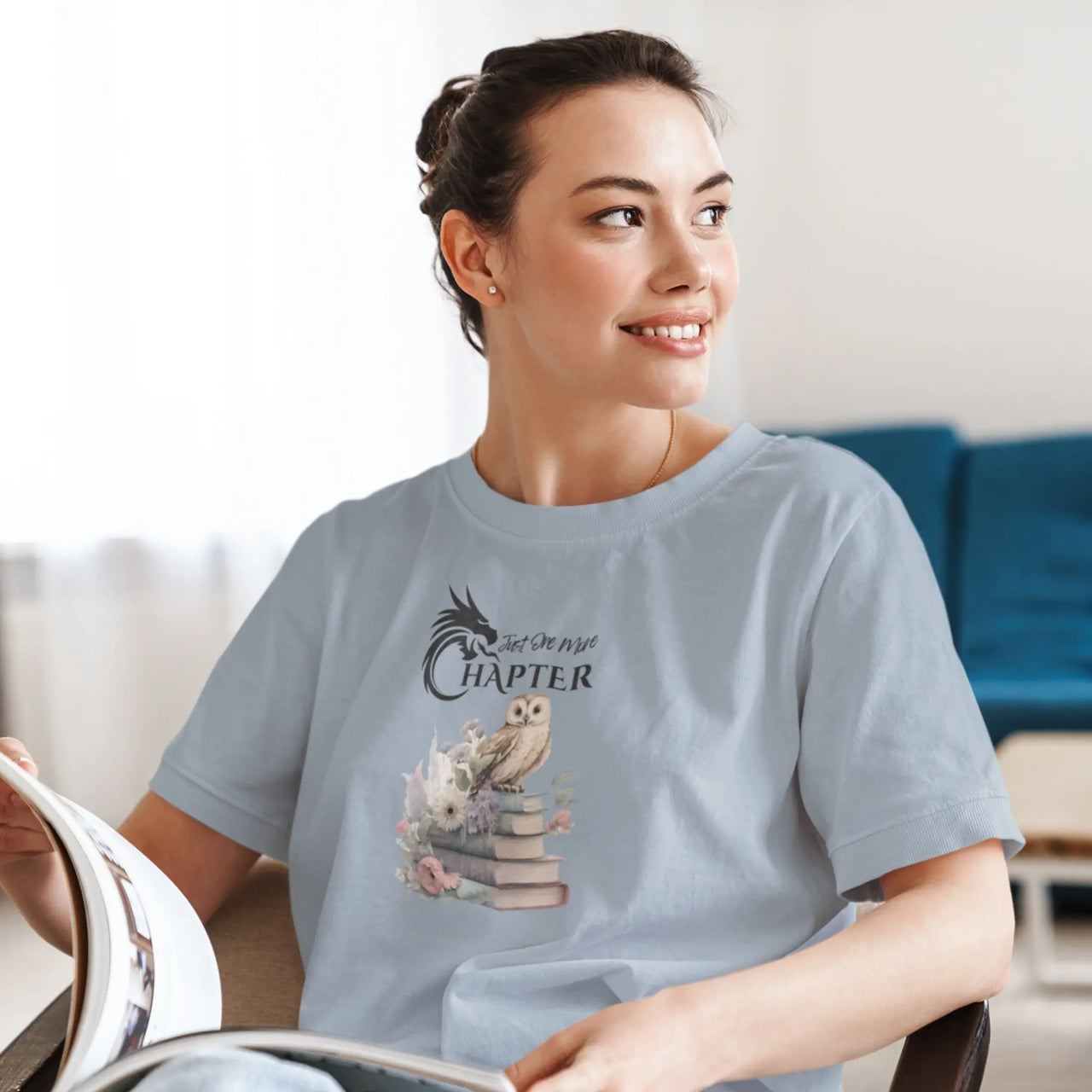 woman reading wearing a Light blue Just One More Chapter T-shirt V3 with black text