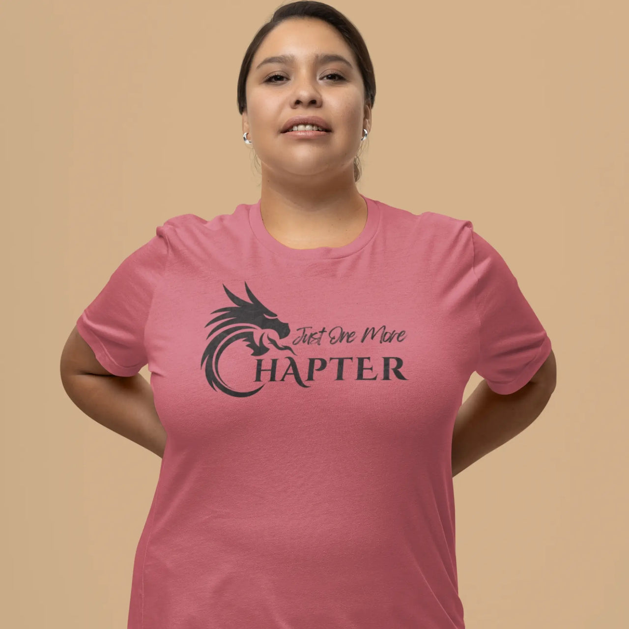 woman wearing a dark pink Just one more chapter tshirt with black text