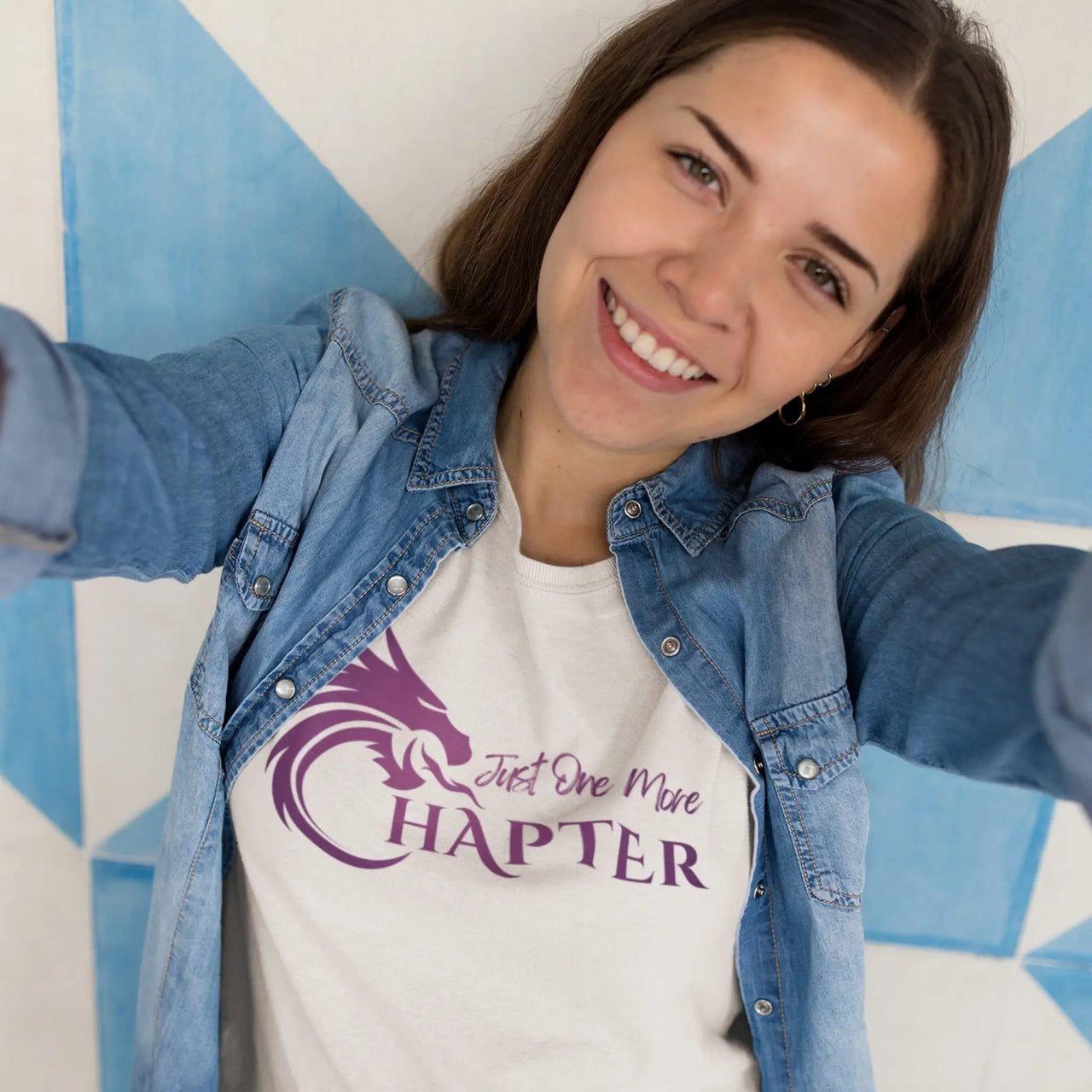 woman wearing a white Just one more chapter tshirt purple text