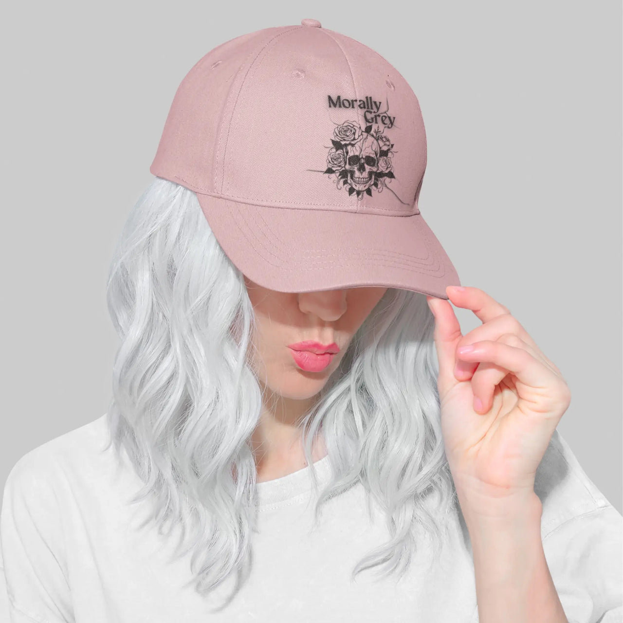 a woman wearing a pink Morally Grey cap