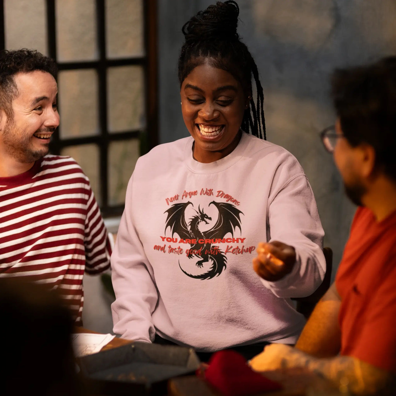 woman rolling a d20 in a Pink Never Argue with Dragons sweatshirt