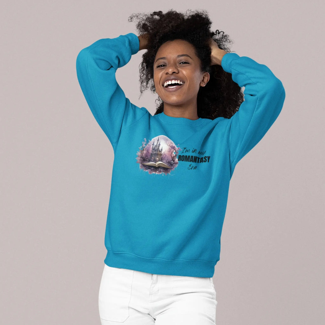 woman smiling while wearing the teal In My Romantasy Era sweatshirt horizontal design