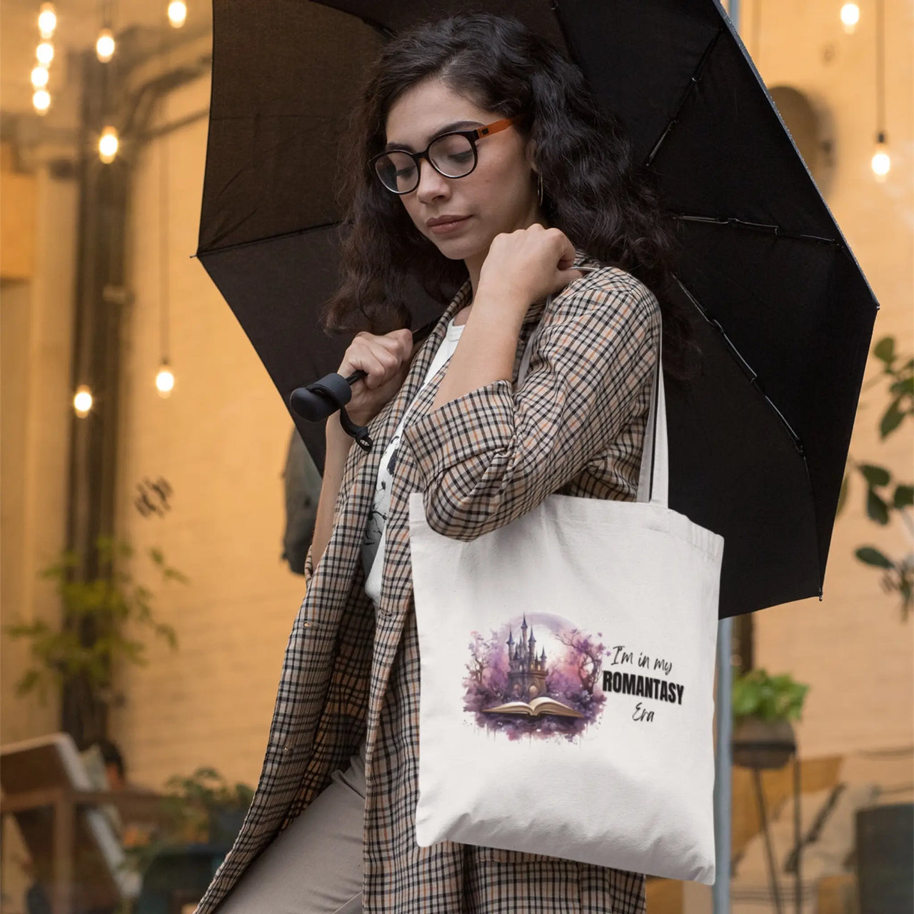 a woman with an umbrella and her tote bag