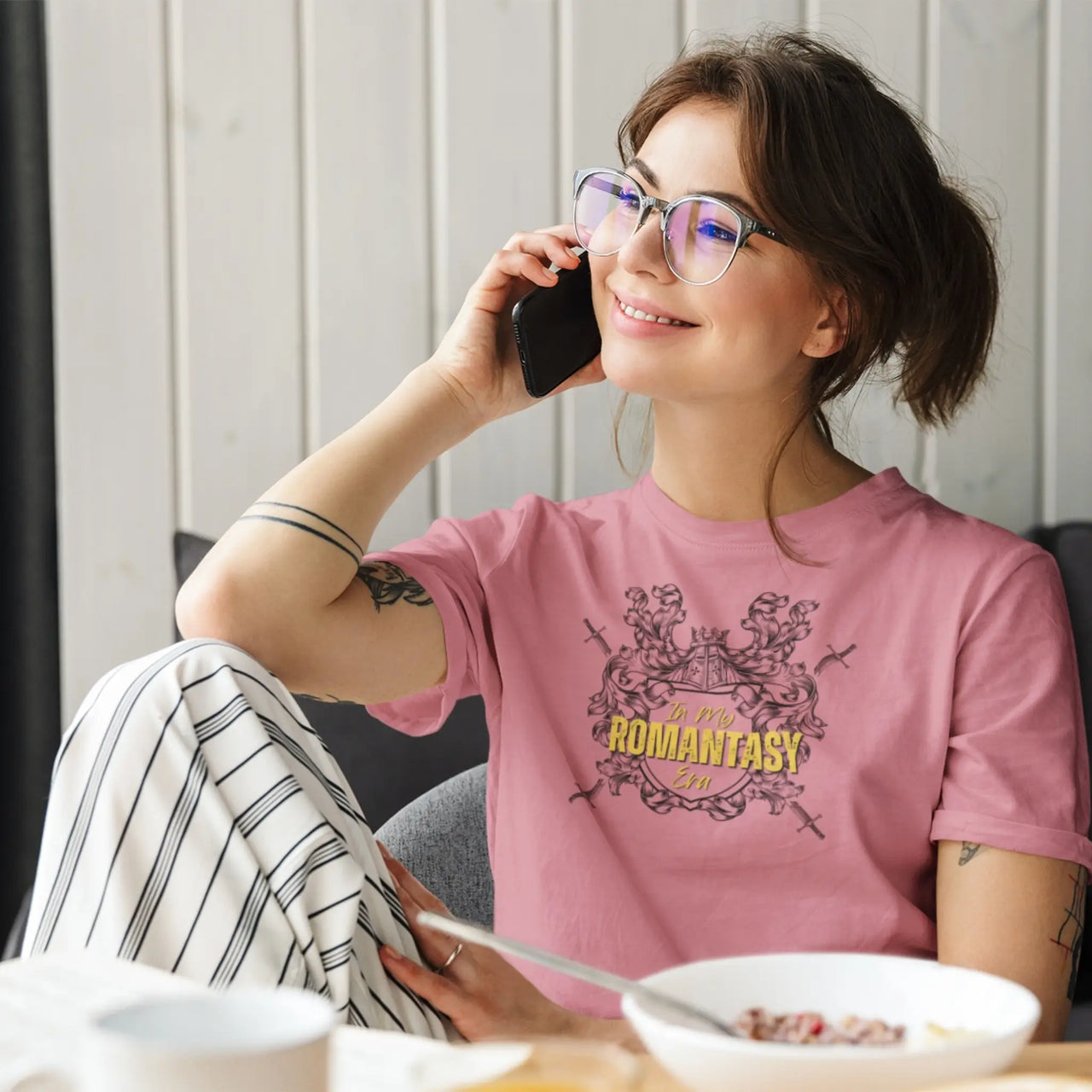 woman on the phone wearing a dark pink In My Romantasy Era Tshirt V4 with yellow text