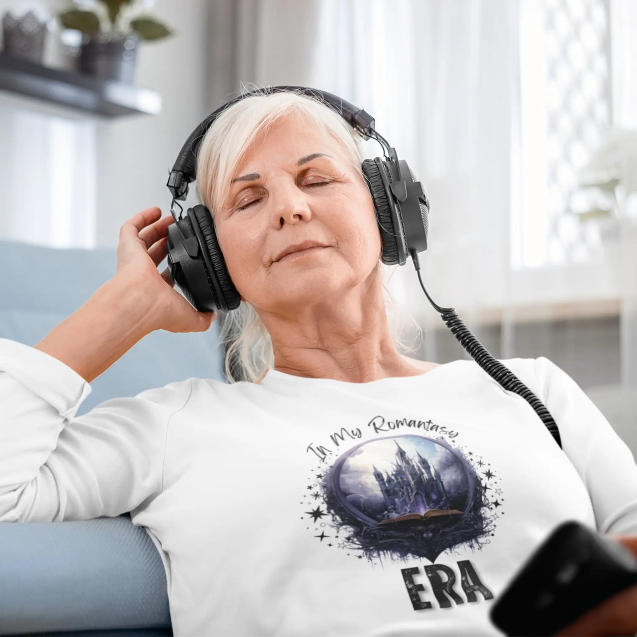 woman with a headset wearing a In My Romantasy Era V2 long sleeve on white