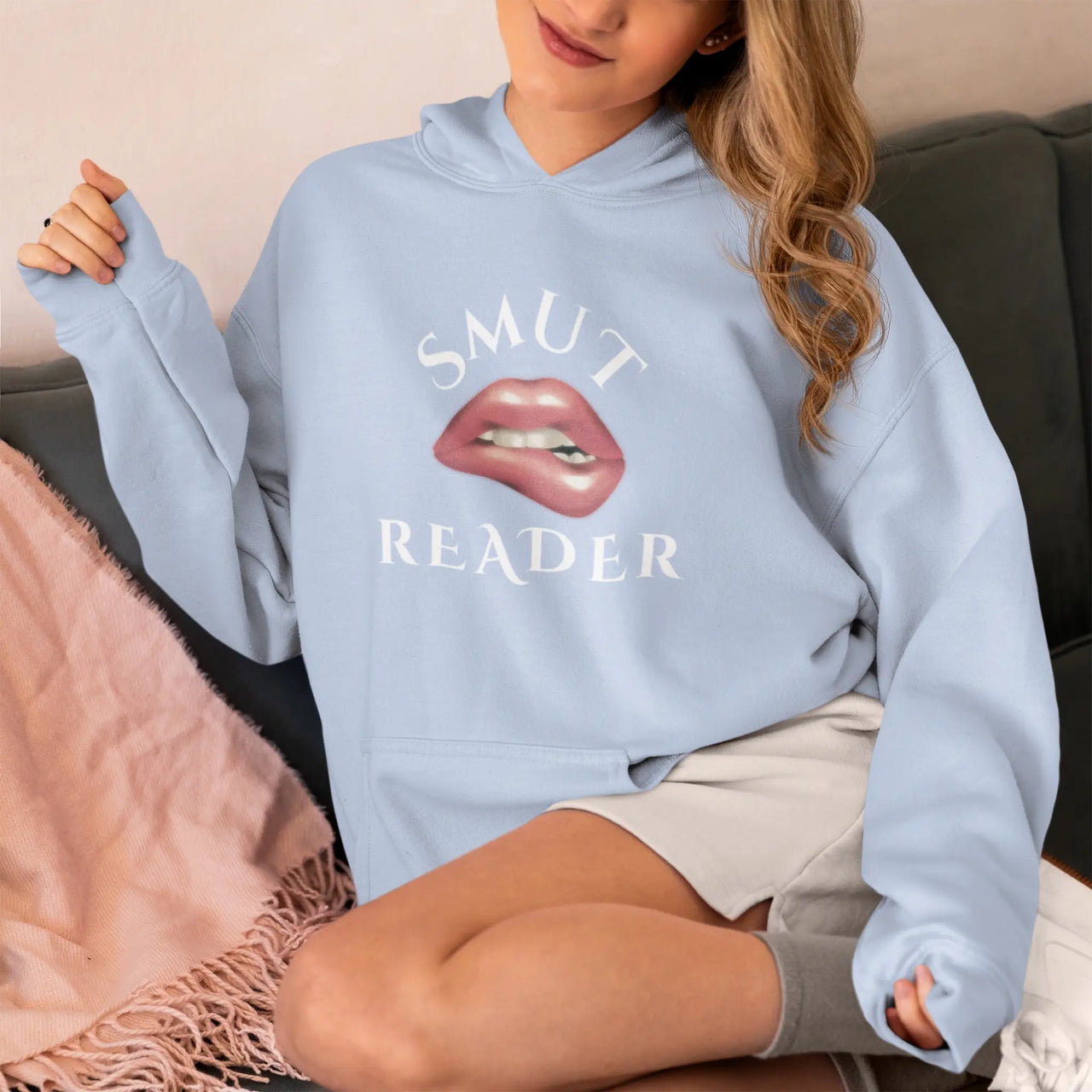 woman wearing a blue Smut Reader Hoodie V2 with white text