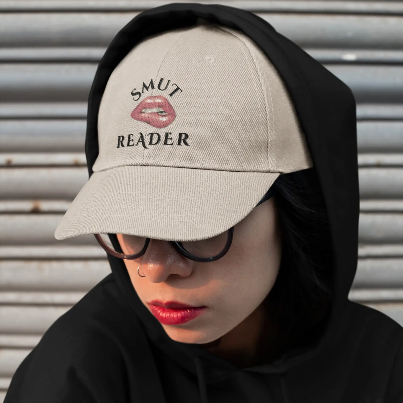 woman wearing a beige smut reader cap and a hoodie