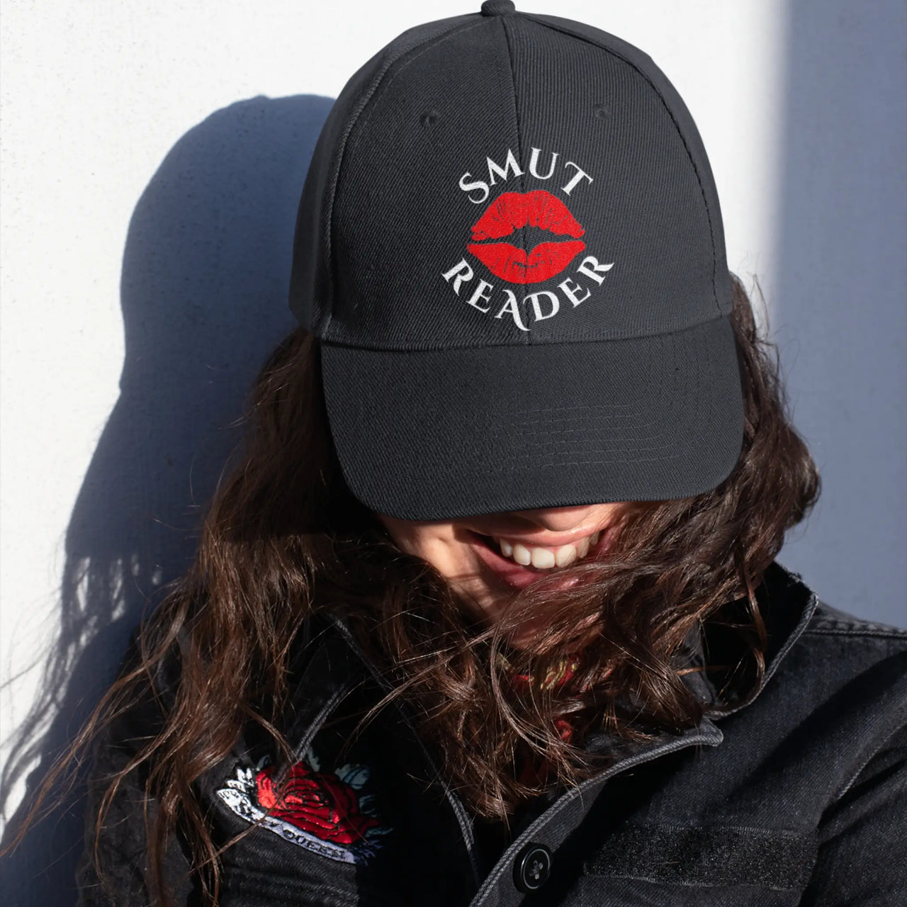 woman wearing a black smut reader cap