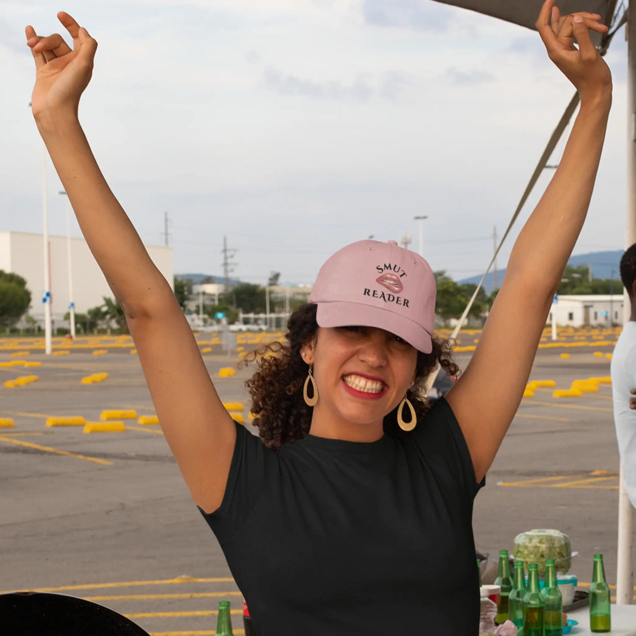 happy woman wearing her pink smut reader cap