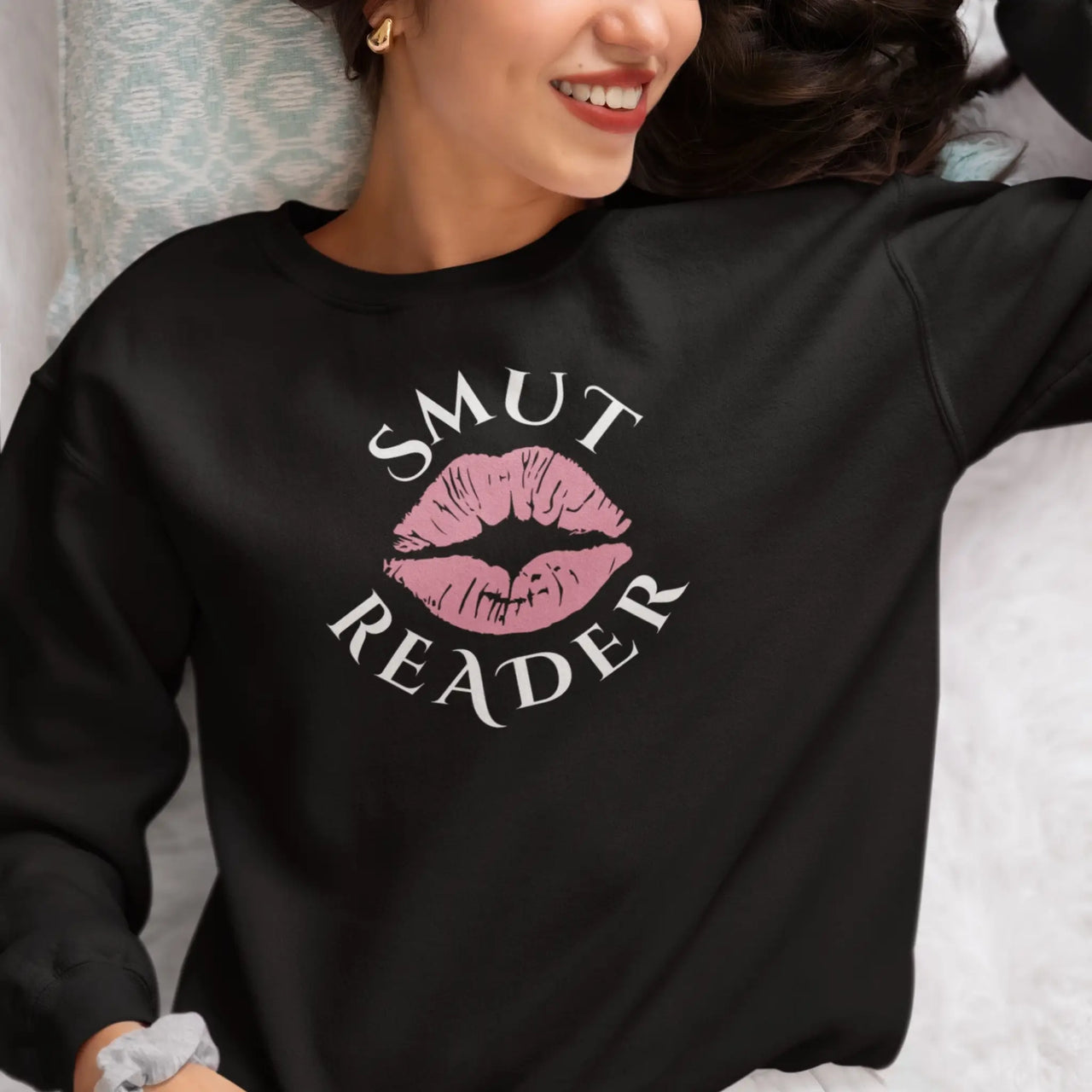 woman wearing a black smut reader sweatshirt pink lips