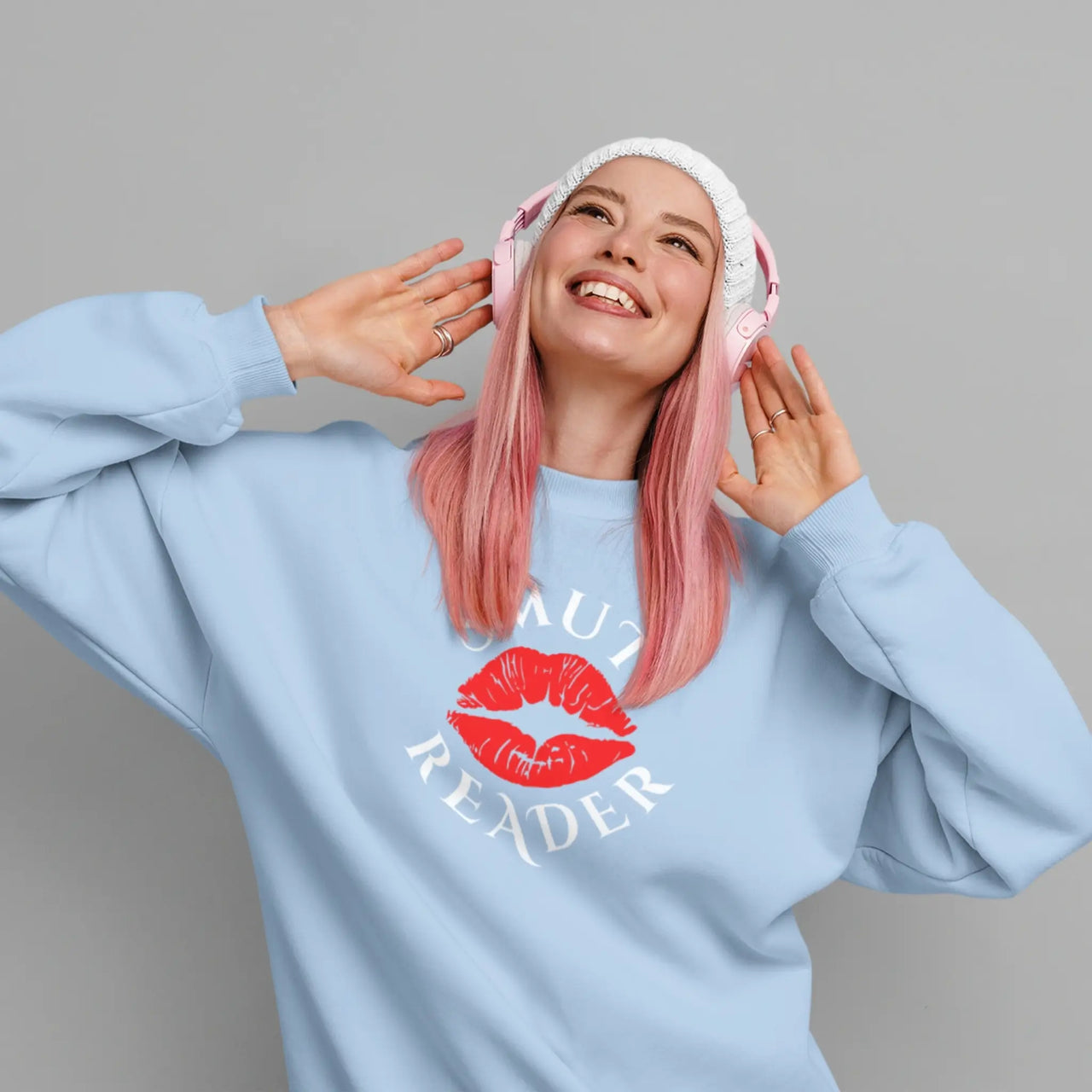 woman wearing a light blue smut reader sweatshirt with white text