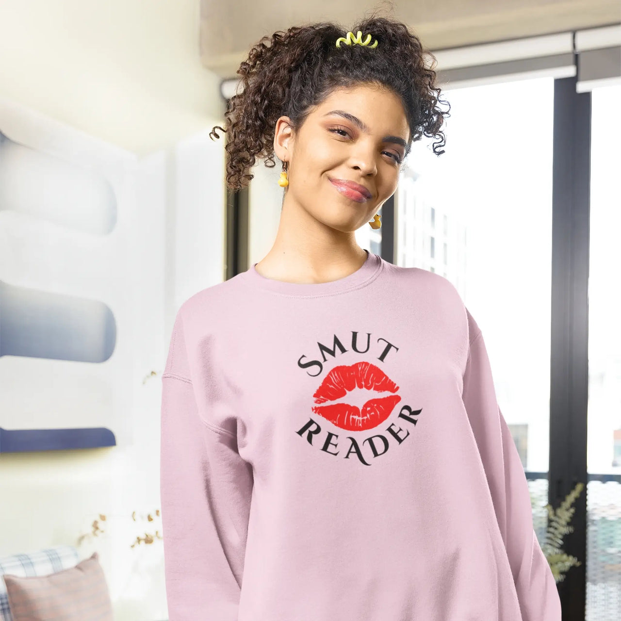 model wearing a pink smut reader sweatshirt