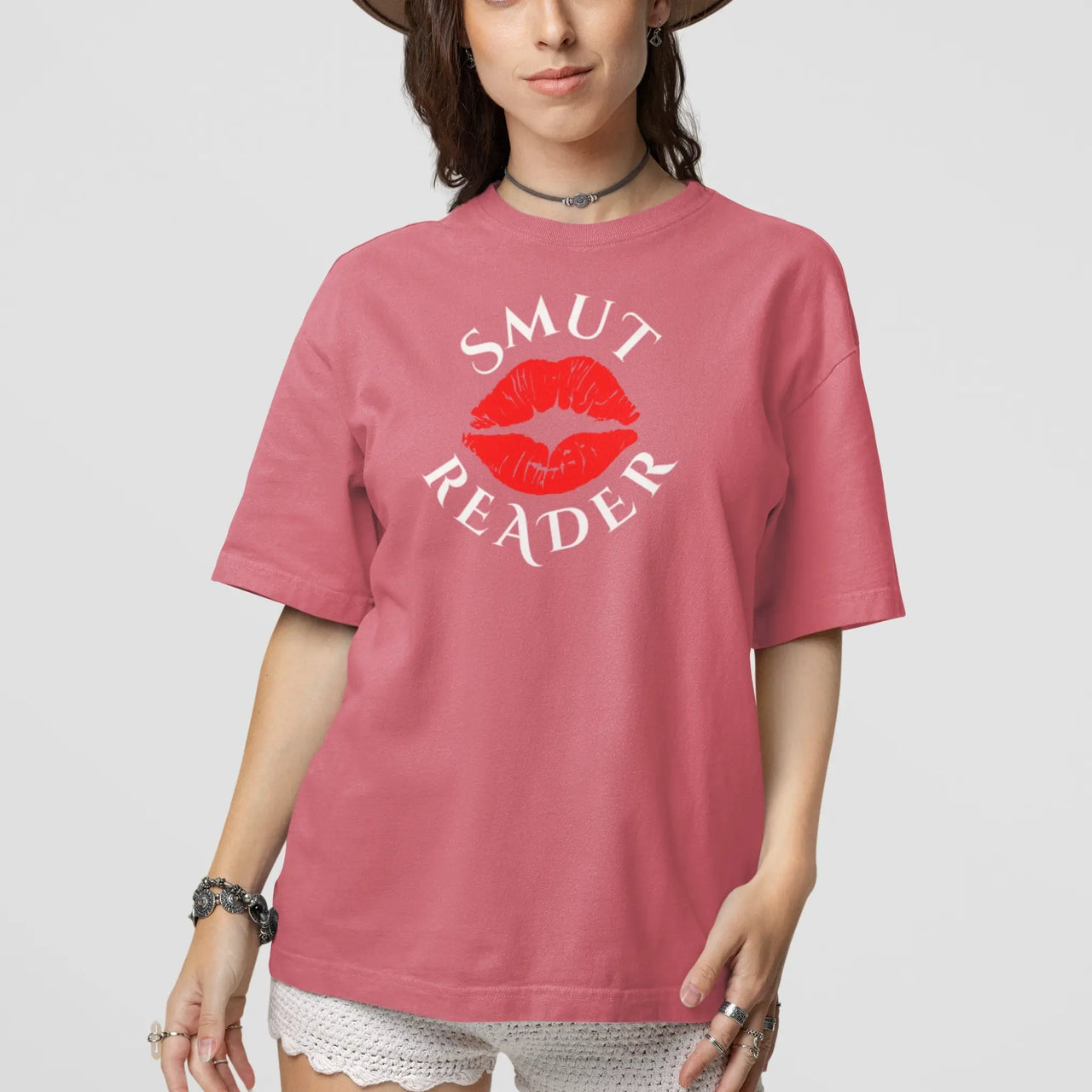 woman wearing a dark pink smut reader v1 tshirt white writing