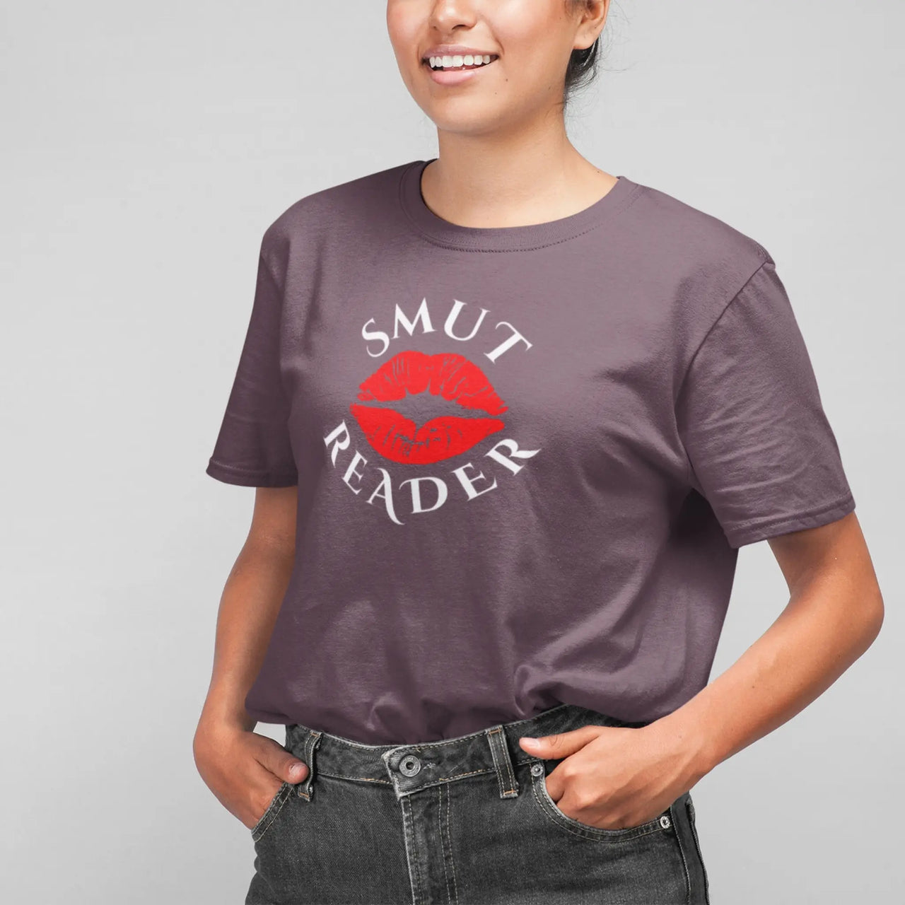 woman wearing a maroon smut reader v1 tshirt white writing