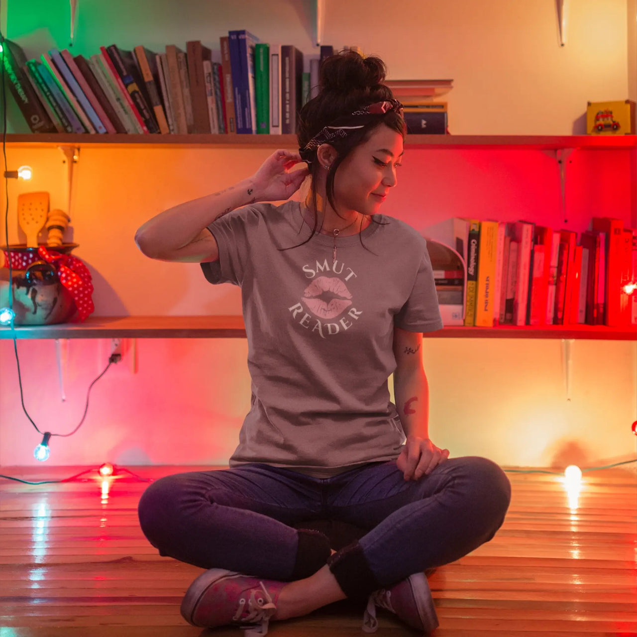 woman wearing a maroon smut reader t-shirt pink lips