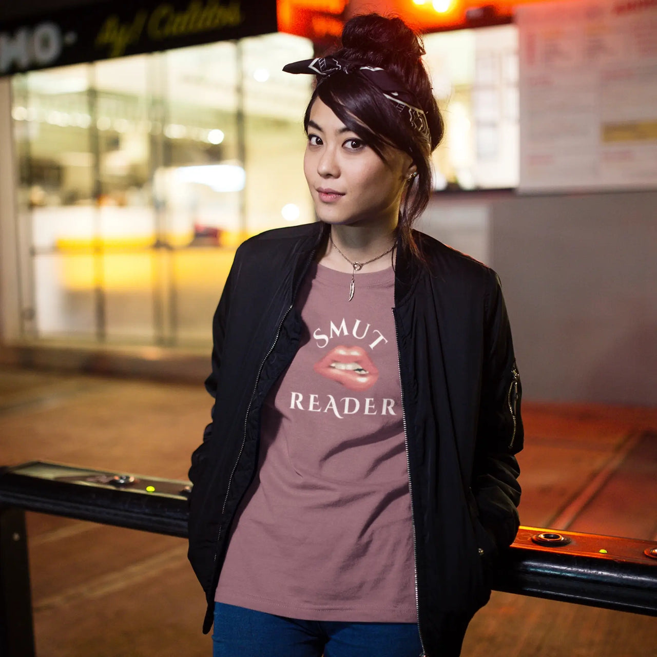 a woman wearing the heather maroon smut reader v3 tshirt with white text